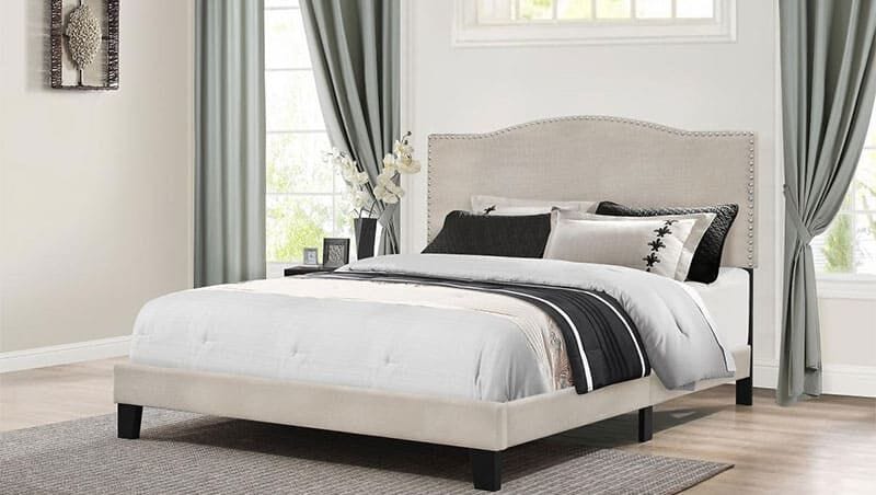 a bed with a black and white headboard