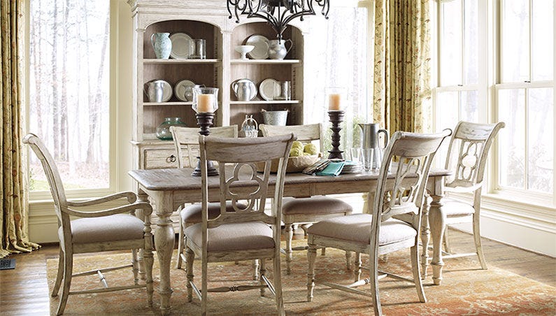 a dining room with a table and chairs