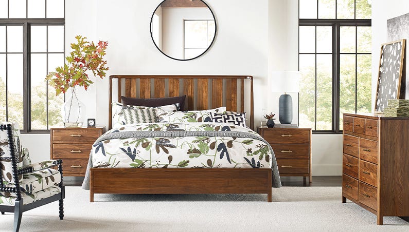 a living room with a bed and a chair
